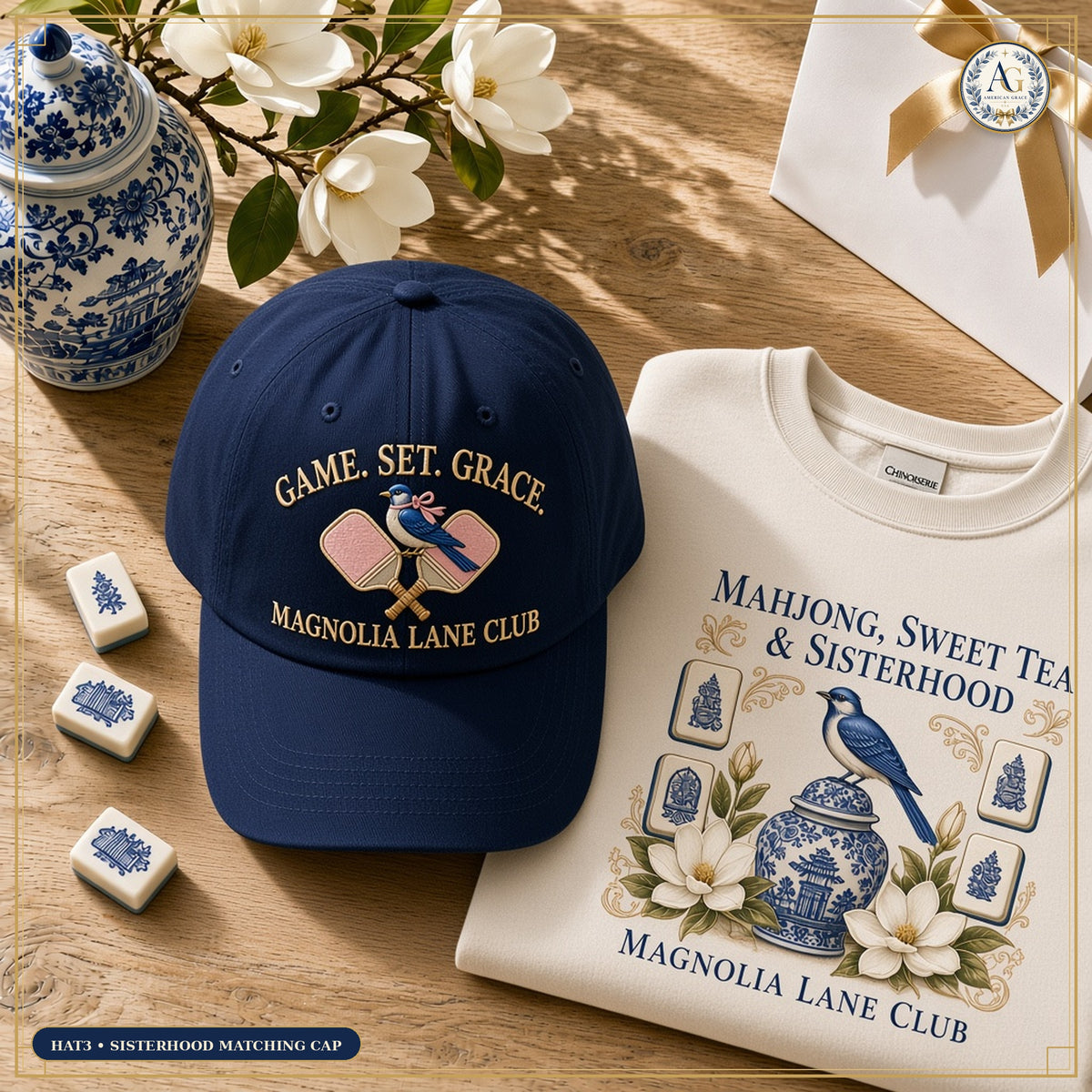 The American Grace Sisterhood Game Set Grace Magnolia Lane Club Embroidered Cap in Heritage Navy paired with matching SW3 Crewneck on warm white oak table